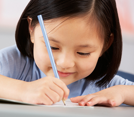 young asian student taking a school test