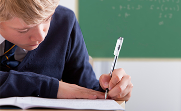 student taking a paper-based school assessment