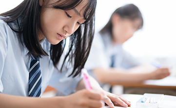 female asian student taking a school test