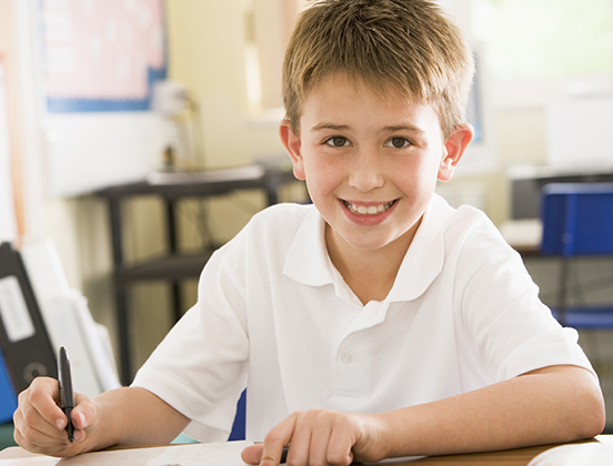 young happy student completing assessment