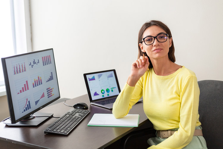 professional lady in yellow looking at school reports